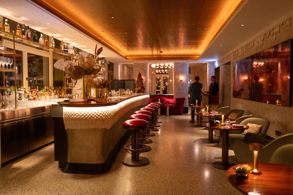 Elegant hotel bar interior with ambient lighting and modern furniture for a refined dining experience.