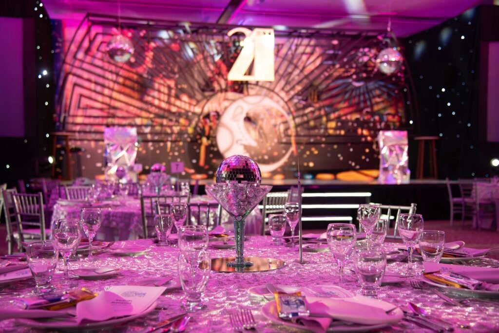 Luxurious dining setup for a 21st birthday party with a sparkling modern theme.